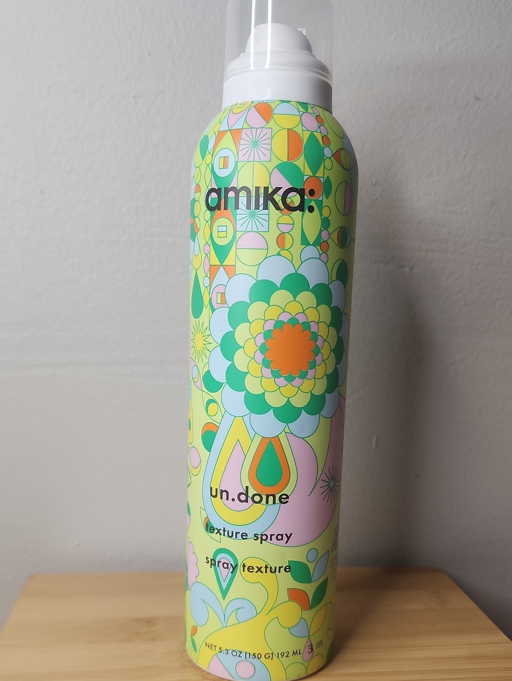 amika texture spray in green, yellow, orange, pink